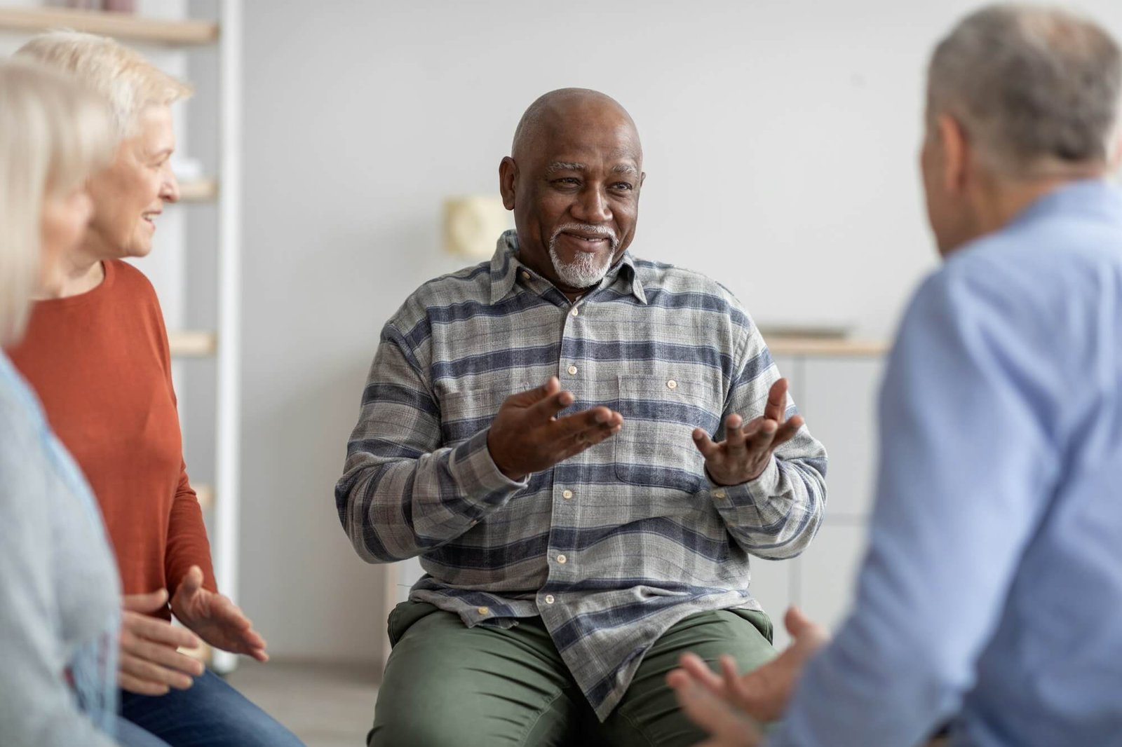 cheerful-african-american-elderly-man-having-conversation-with-coach.jpg